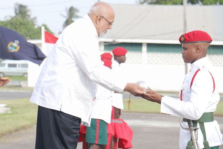 President Donald Ramotar today presenting the Sword of Honour to Simon Gordon, Best Student of Standard Officers’ Course #46 at the Drill Square Base Camp Ayanganna, Thomas Lands.