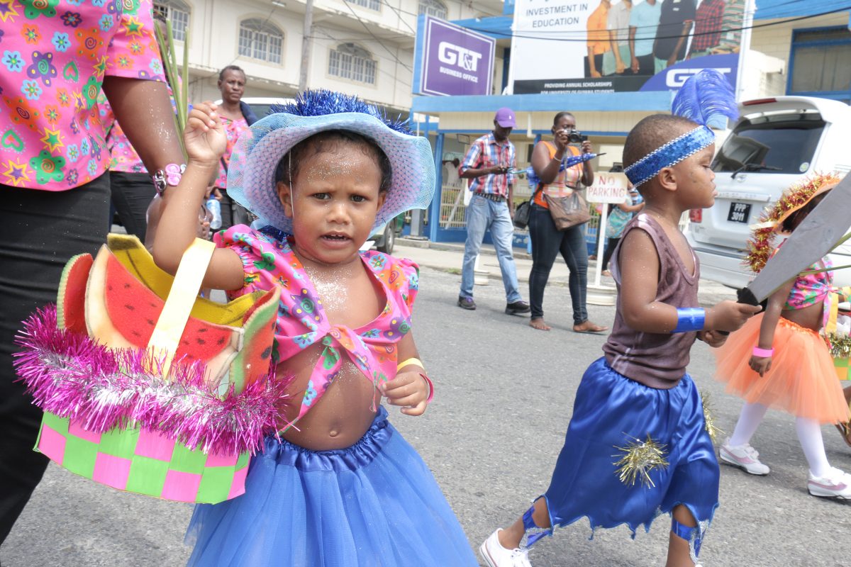 My basket is too heavy! This young one from the Festival City Day Care Centre seems to be a bit overwhelmed during a mini Mash parade today (Photo by Arian Browne)