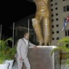 Sir Viv stands next to his statue