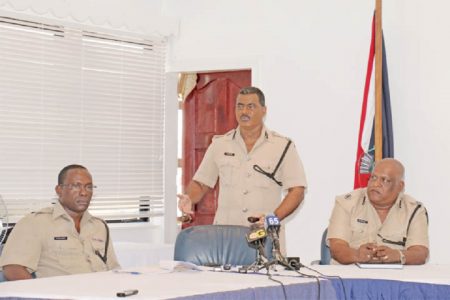 Assistant Commissioner David Ramnarine (centre) yesterday updating the media on the 71 recommendations made by the Discipline Forces Commission (DFC) for the reform and modernisation of the Guyana Police Force. In this Arian Browne photo Assistant Commissioner Balram Persaud (right) and another police officer look at the PowerPoint presentation being made by Ramnarine.