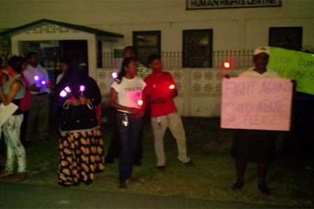 A section of people gathered outside of the GHRA building with candles to speak out against the abuse of a one-year-old baby.