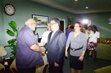 President Donald Ramotar greets Venezuelan Foreign Minister Elias Jaua at the Cheddi Jagan International Airport. Also in photo is Minister of Foreign Affairs Carolyn Rodrigues-Birkett. (Gina photo)