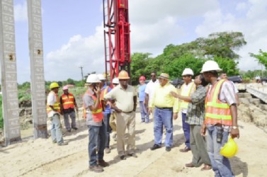 President Donald Ramotar (centre), Minister of Public Works, Robeson Benn (second from left),  Finance Minister, Dr Ashni Singh (second from right) and several engineers at Little Diamond, East Bank Demerara.  (GINA photo)