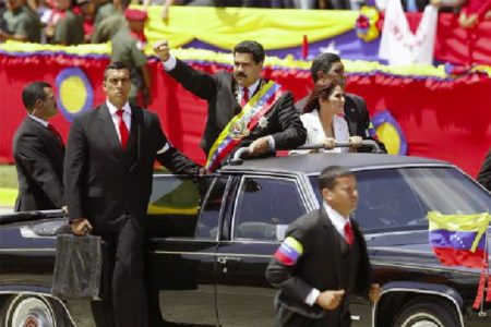 Venezuela’s President Nicolas Maduro (C) arrives at a military parade to commemorate the first anniversary of the death of Venezuela’s late president Hugo Chavez in Caracas March 5, 2014. Credit: Reuters/Jorge Silva

