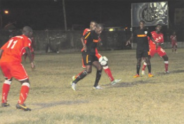 Slingerz FC forward Anthony Abrams (black) attempting to shield the ball from his Boystown marker in the opening half  
