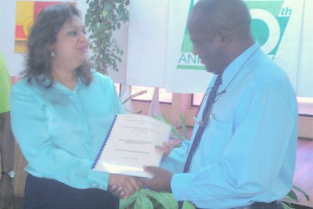 Education Minister Priya Manickchand presents one of the contracts to University of Guyana Vice-Chancellor Jacob Opadeyi.  