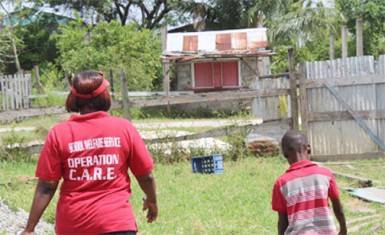 In this Ministry of Education photo, a school welfare officer escorts a child back home. 