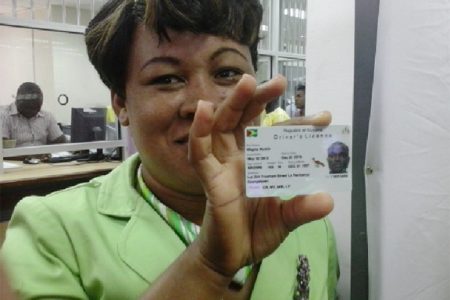  GRA’s Public Relations Manager, Marcia Harris displays one of the new automated driver’s licences.