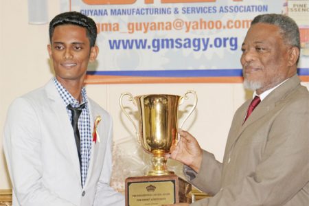 The Guyana Manufacturing and Services Association’s President’s Award was bestowed on Pritipaul Singh Investments last Thursday at its annual awards ceremony at the Pegasus Hotel. In photo Pritipaul Singh Jr receives the award, on behalf of his father, from Prime Minister Samuel Hinds. (Arian Browne photo)
