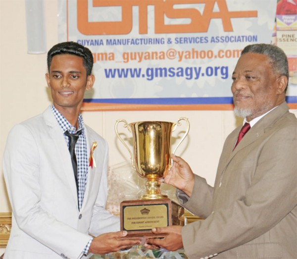 The Guyana Manufacturing and Services Association’s President’s Award was bestowed on Pritipaul Singh Investments last Thursday at its annual awards ceremony at the Pegasus Hotel. In photo Pritipaul Singh Jr receives the award, on behalf of his father, from Prime Minister Samuel Hinds. (Arian Browne photo)