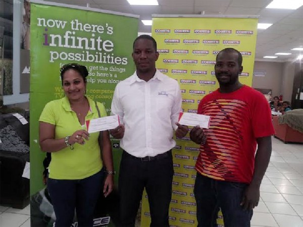 From left are Raemona Urling, Courts Marketing Manager Pernell Cummings and Quaison at Courts, Main Street yesterday. The promotion which ran from January 21 to February 14 was focused on sharing the love by promoting bedroom ranges at unbelievable prices for customers who purchased any item over $29,999. Urling and Boodie each won a romantic getaway for two at the Pegasus Hotel.  