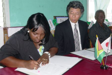 Jacqueline Cummings-Johnson and Ambassador, Yoshimasa Tezuka during the signing ceremony
