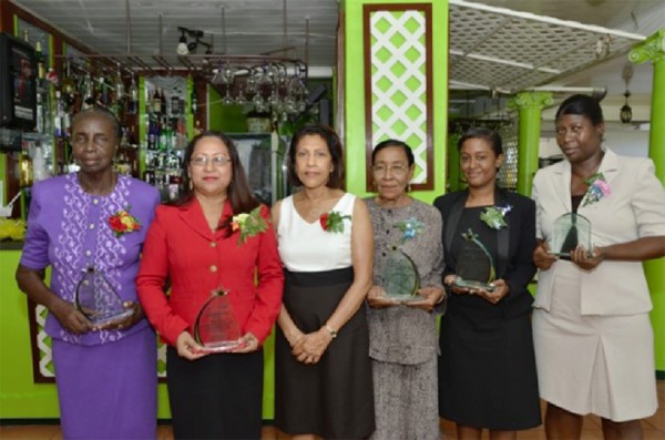 The Guyana Parliament yesterday honoured women in its annual International Women’s Day luncheon at Duke Lodge, Kingston for long and dedicated service. GINA said that those honoured with special awards were Government Members of Parliament, past and present, Minister of Amerindian Affairs Pauline Sukhai for 20 years of service; Philomena Sahoye-Shury for 15 years of service; and Shirley Edwards for 18 years of service. Opposition Member of Parliament Deborah Backer was also honoured for 14 years of service and staff member of the Parliament Office Eleanor Coddett for 30 years of service. From left to right are: Shirley Edwards, Philomena Sahoye-Shury, First Lady Deolatchmee Ramotar, Amerindian Affairs Pauline Sukhai,  daughter of Opposition Member of Parliament Deborah Backer who received her mother’s award and staff member of the Parliament Office Eleanor Coddett. (GINA photo)   