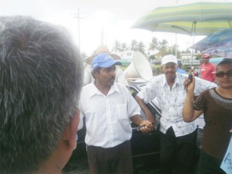 Chairman of the Essequibo Paddy Farmer Association Naith Ram, speaking with the protesters 
