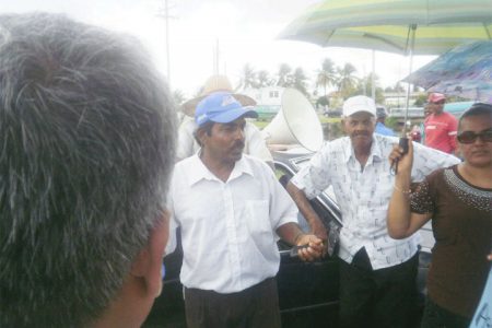 Chairman of the Essequibo Paddy Farmer Association Naith Ram, speaking with the protesters