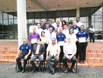 From left, front row: Assistant Superintendent S Bacchus, Computer Consultant Naresh Singh, Force Training Officer Paul Williams and Senior Vice President of Zhara Group of Companies J Subraj. Behind them are the graduates of the PC Repairs/Maintenance Course. 