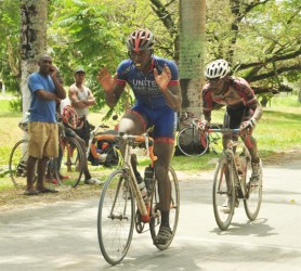 Team United’s Orville Hinds crossing the finish line to take the spoils of the feature 35-lap event of the 9th annual Diamond Mineral Water 11-race programme. Junior Niles, the other rider in the photo was lapped by Hinds. (Orlando Charles photo)  