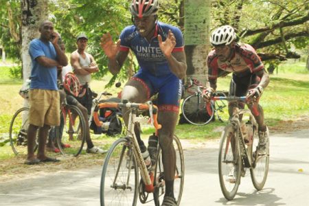 Team United’s Orville Hinds crossing the finish line to take the spoils of the feature 35-lap event of the 9th annual Diamond Mineral Water 11-race programme. Junior Niles, the other rider in the photo was lapped by Hinds. (Orlando Charles photo)
