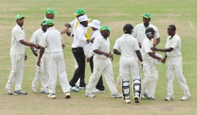 The players and umpires greet each other after the light was taken by the Guyanese players. (Orlando Charles photo)