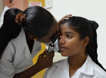 Junior Medical Officer, Dr Bobb-Semple, doing an ophthalmoscopy.