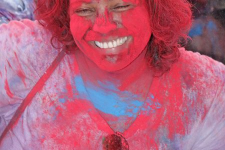 Red is definitely her colour! A Phagwah reveller at Inspire Inc’s activity at the Guyana National Stadium, Providence yesterday. 