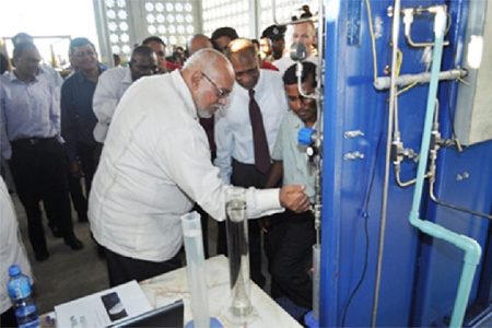 President Donald Ramotar drawing bio-fuel from the Albion plant at its launching (GINA photo)
