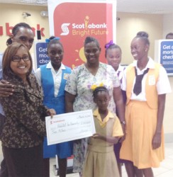 Jennifer Cipriani of Scotiabank (far left) hands over a symbolic $2 million cheque to the youngest of Althea Boucher’s four daughters as the proud mother, her other three daughters and a Habitat for Humanity representative look on. 