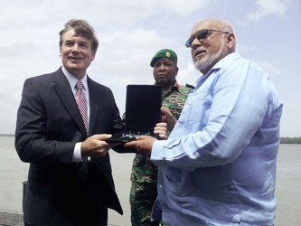 US Ambassador D. Brent Hardt (left) hands over the keys of the three vessels to President Donald Ramotar, as Chief of Staff of the Guyana Defence Force, Brigadier Mark Phillips looks on. 