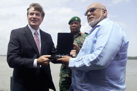 US Ambassador D. Brent Hardt (left) hands over the keys of the three vessels to President Donald Ramotar, as Chief of Staff of the Guyana Defence Force, Brigadier Mark Phillips looks on.
