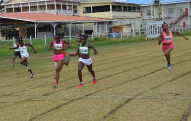 Jevina Sampson about the cross the finish line ahead of Avon Samuels in the 200m under-18 Girls event.  