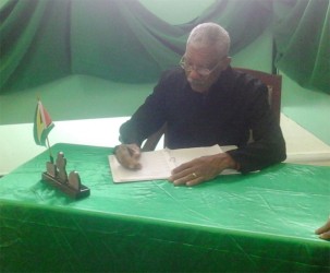 Opposition Leader David Granger signing the book of condolence in honour of PNCR Executive member Deborah Backer who died on Friday. 