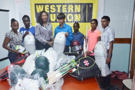 Marketing Representative of Western Union, Natheeah Mendonca (third from left), present cricket equipment to Akshay Homraj in the presence of the other recipients.
