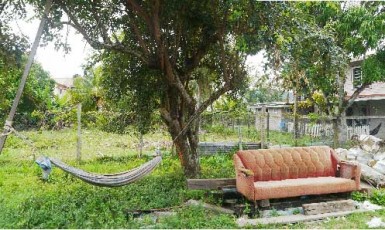A hammock and chair across the street in front of residents' home
