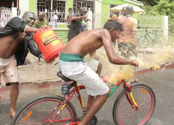 Literally riding the gauntlet: This Alexander Village cyclist couldn’t escape this water thrower.