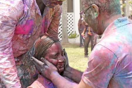 Coloured: This woman having her face powdered during Phagwah festivities at the Indian Cultural Centre today.