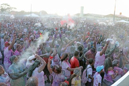 Achoo! Clouds of powder rising in the air at the Guyana National Stadium, Providence on Monday as Phagwah was celebrated by thousands at the Inspire Inc’s activity. (Photo by Arian Browne)