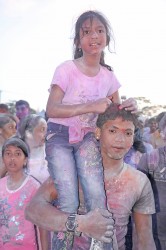 On high: This girl got a lift at the National Stadium to inspect the phagwah festivities on Monday.