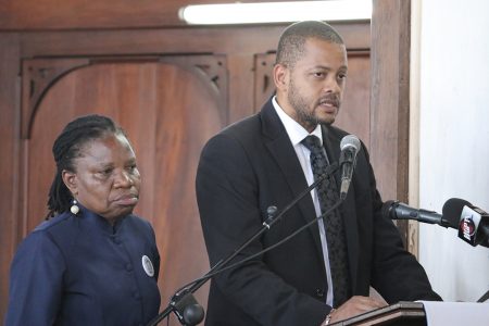 Head of the Guyana Bar Association Ronald Burch-Smith and Attorney at law Emily Dodson paying their last respects to Deborah Backer