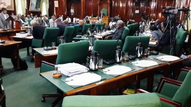 The empty AFC seats (right) as the Finance Minister (left) speaks.