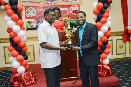 Dr Roscoe Mc Donald (right) receives the Dr. Motilall Award for TB HIV service at the Pegasus Hotel yesterday. (GINA photo)