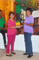 Mary McDonald receiving her overall prize of a trophy and Miracle Gro from Peggy Chin 