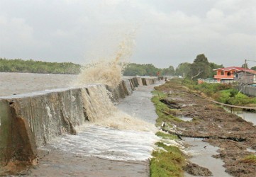 Sea defence takes a battering at Mahaica: High waves pounding the crumbling Mosquito Hall, Mahaica sea defence yesterday afternoon.  