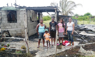 Nadira Johnson with her daughters; Rashel and Radha. Her older daughter, Chandini and grandson, Anthony, 3, who live nearby are at left.