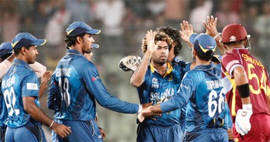 Sri Lankan players celebrate after the fall of Dwayne Smith’s wicket. (WICB photo)