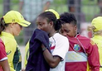 West Indies players Stafanie Taylor and Shanel Daley weep openly following their loss to Australia in the women’s semi-final yesterday. (Photo courtesy WICB Media) 