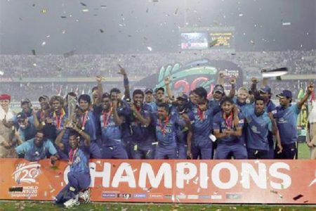 Sri Lanka’s players celebrate with the trophy after winning the ICC Twenty20 World Cup cricket title after beating India at the Sher-E-Bangla National Cricket Stadium in Dhaka yesterday.