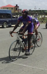 Orville Hinds about to cross the finish line ahead of Team Alanis’ Paul DeNobrega in yesterday’s third annual Powerade 50-mile road race.  