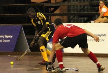 Guyana’s Jamarj Assanah attempting to pass the ball while being challenged by USA’s Williams Holt during their group matchup 