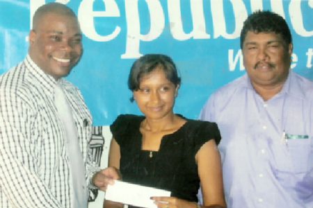 Republic Bank Manager Randolph Sears (left) hands over sponsorship cheque to Alisa Moonsee, at right is Anil Beharry BCB 1st Vice President