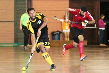 Guyana’s Rafael DeGroot (left) on the attack against Canada during their group match-up. 